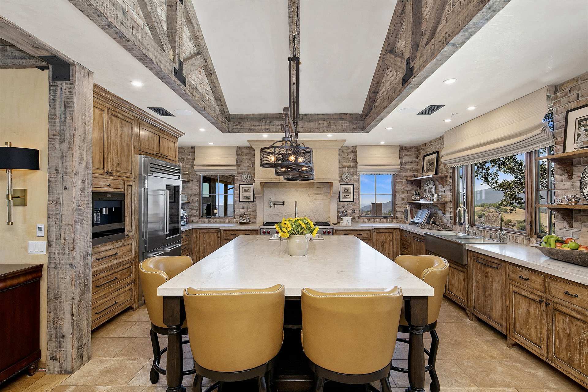 Chef's kitchen with barstools around an island countertop
